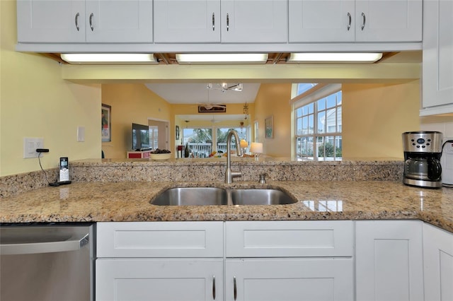 kitchen with white cabinetry, dishwasher, sink, and light stone counters