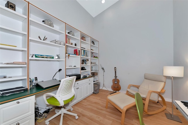 office area with vaulted ceiling and light hardwood / wood-style floors