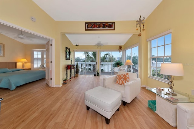 interior space featuring multiple windows, lofted ceiling, and light hardwood / wood-style flooring