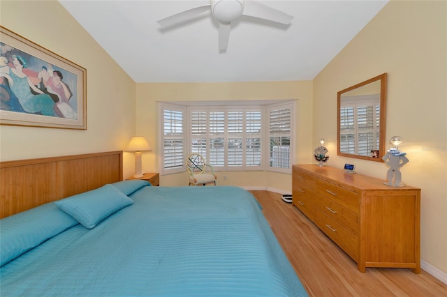 bedroom featuring vaulted ceiling, ceiling fan, and light hardwood / wood-style flooring