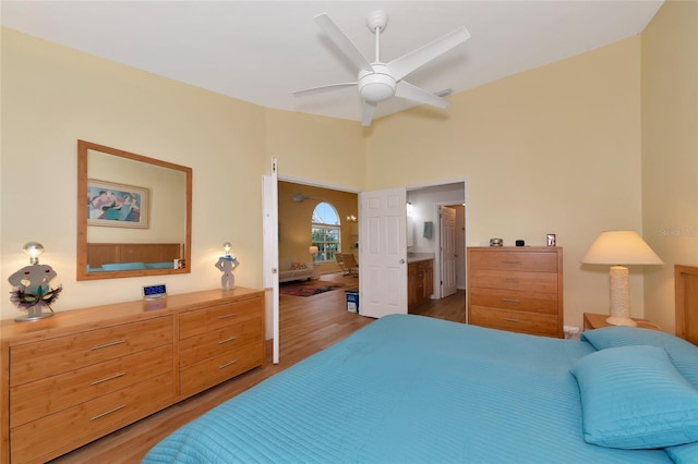 bedroom with connected bathroom, wood-type flooring, and ceiling fan