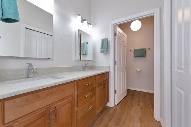 bathroom featuring hardwood / wood-style flooring and vanity