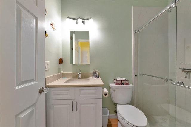 bathroom featuring walk in shower, vanity, and toilet