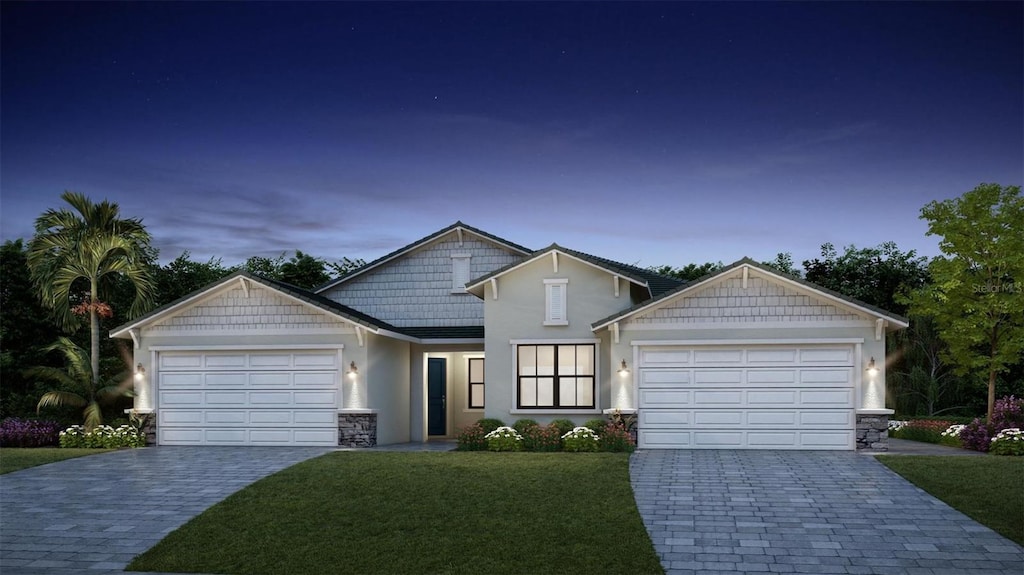 craftsman-style house with a yard and a garage