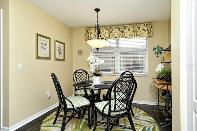 dining space with dark hardwood / wood-style floors