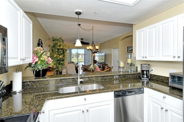 kitchen with sink, stainless steel dishwasher, white cabinets, and decorative light fixtures