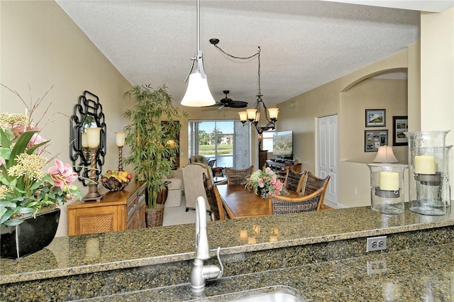 kitchen featuring a chandelier, a textured ceiling, and decorative light fixtures