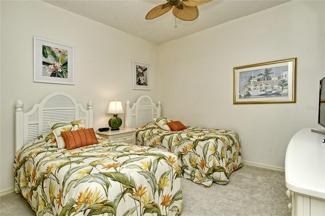 carpeted bedroom with a textured ceiling and ceiling fan