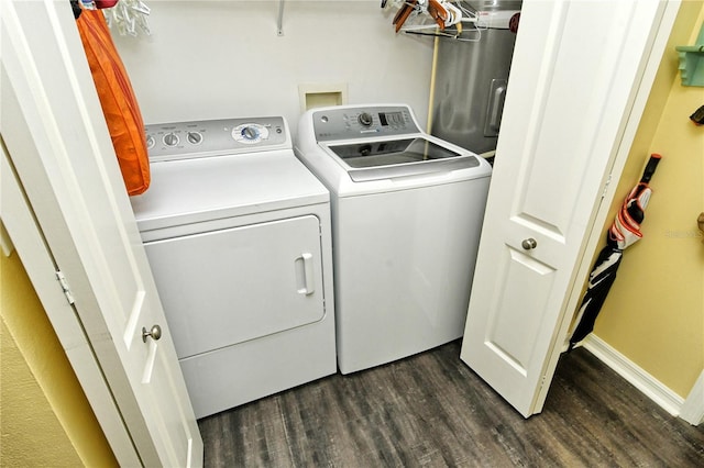 laundry area with dark wood-type flooring and washer and dryer