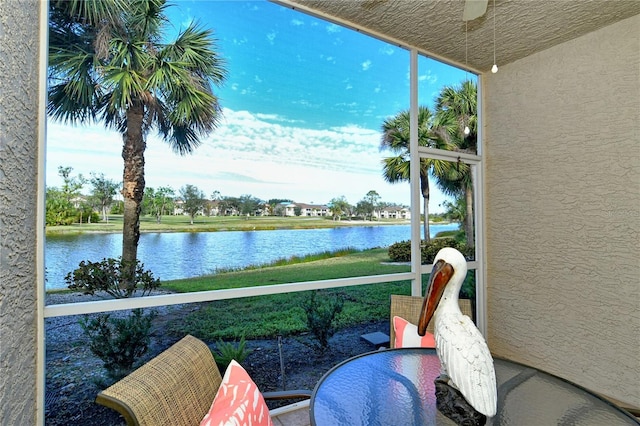 sunroom / solarium with a water view