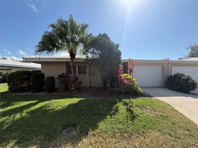 single story home with a garage and a front yard