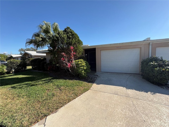 view of front of property featuring a garage and a front yard