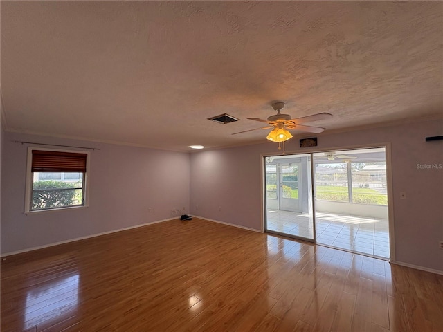 empty room featuring crown molding and hardwood / wood-style flooring