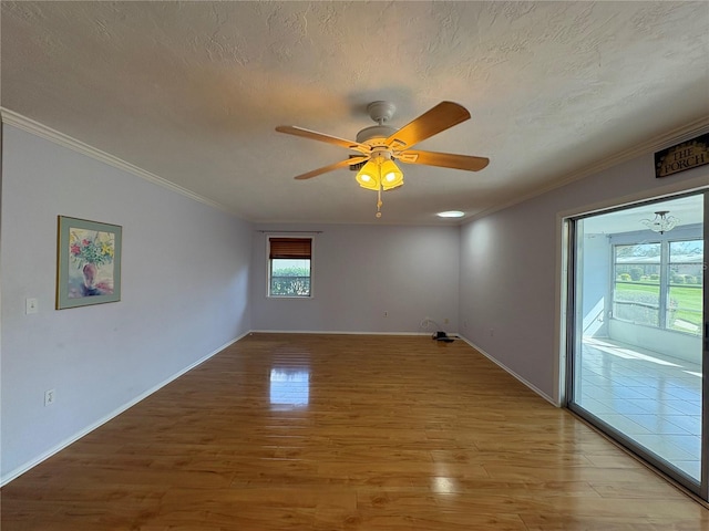 spare room with hardwood / wood-style flooring, ceiling fan, crown molding, and a textured ceiling