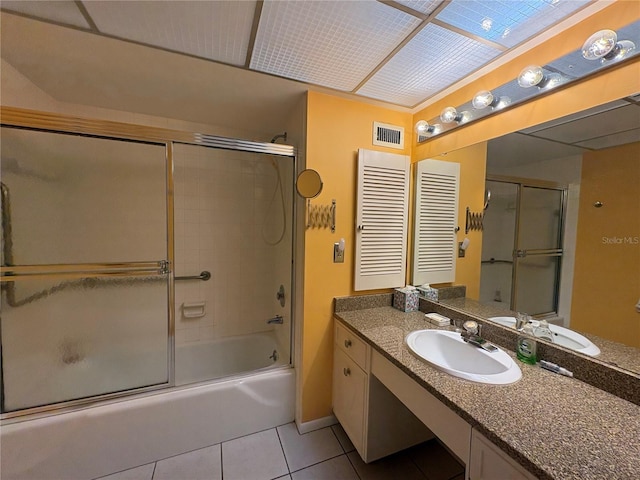 bathroom with vanity, bath / shower combo with glass door, and tile patterned flooring