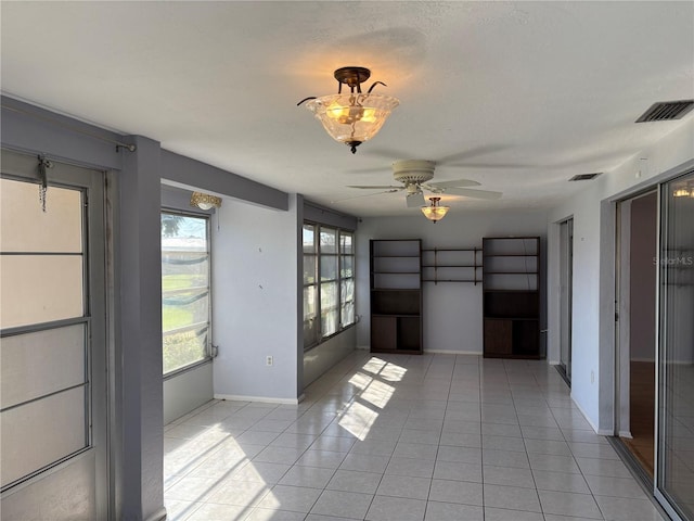 interior space featuring light tile patterned floors and ceiling fan