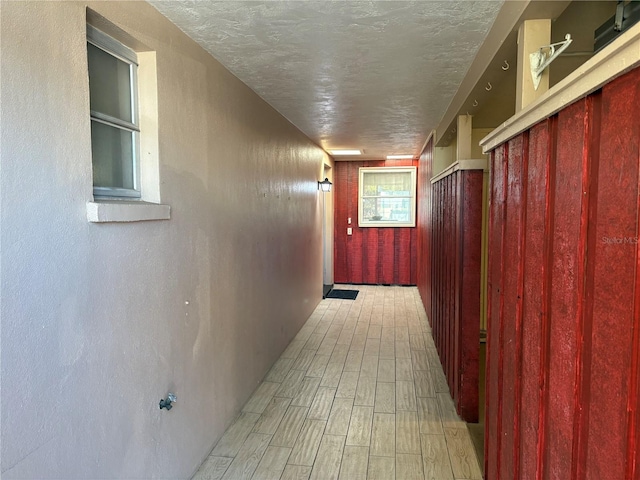 hallway with a textured ceiling