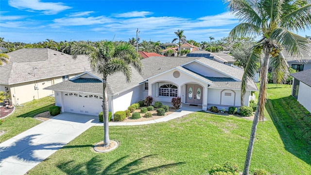 view of front of property with a garage and a front yard