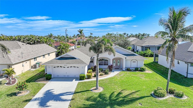 view of front of property with a garage and a front lawn