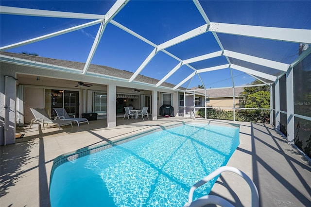 view of pool featuring ceiling fan, a patio, and glass enclosure