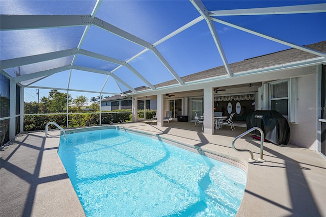 view of pool featuring a grill, a patio, ceiling fan, and glass enclosure