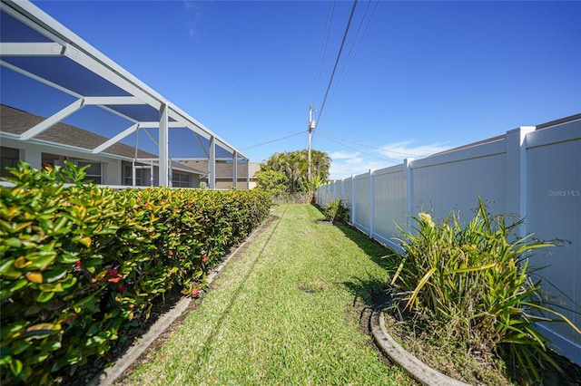 view of yard with glass enclosure