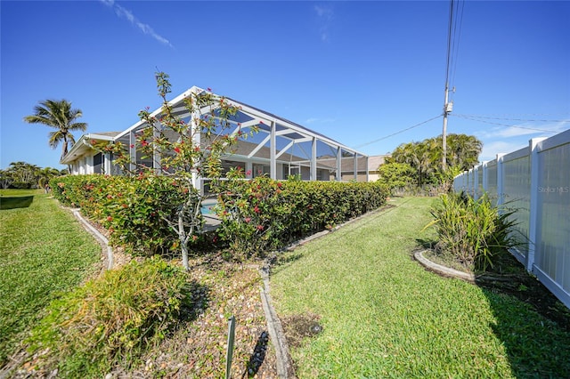 view of yard featuring glass enclosure