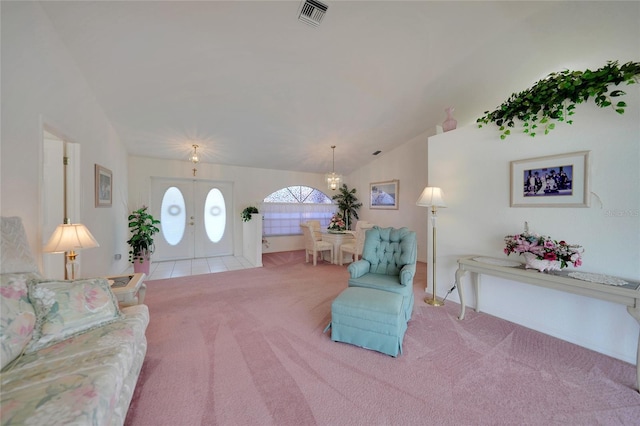 carpeted living room featuring lofted ceiling and french doors