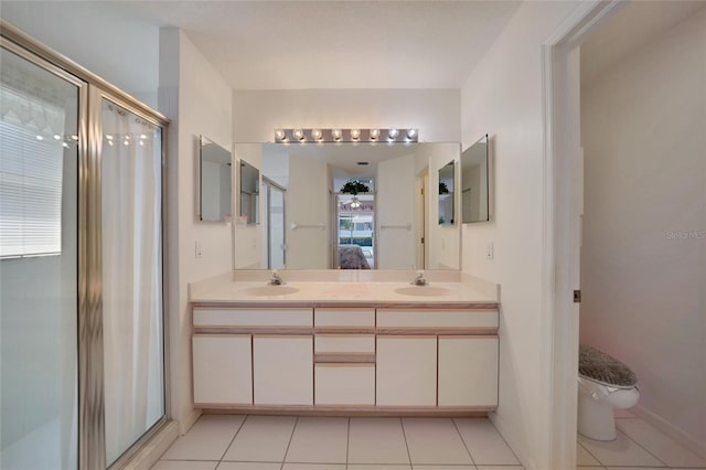 bathroom featuring vanity, walk in shower, tile patterned floors, and toilet