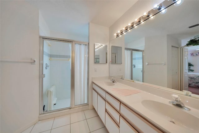 bathroom featuring vanity, tile patterned floors, and walk in shower