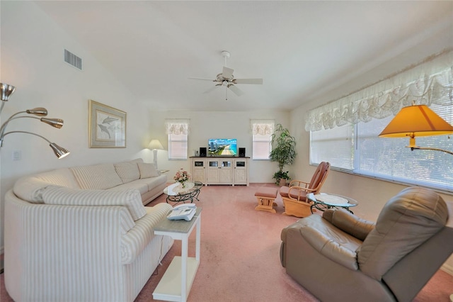 carpeted living room with vaulted ceiling and ceiling fan