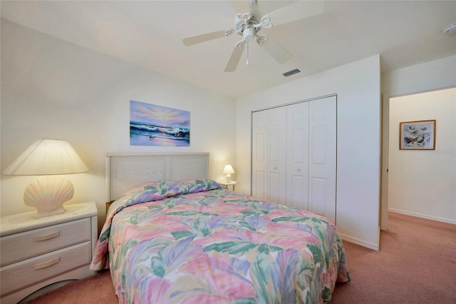 carpeted bedroom featuring ceiling fan and a closet