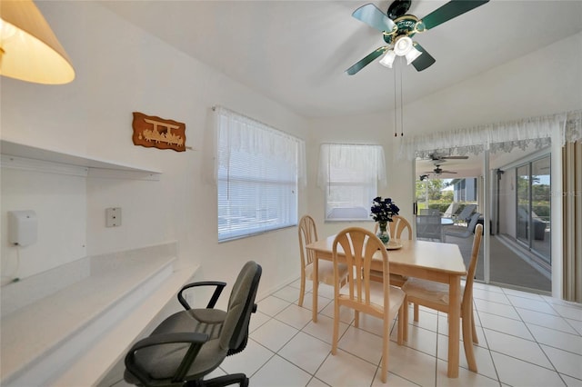 tiled dining room with vaulted ceiling