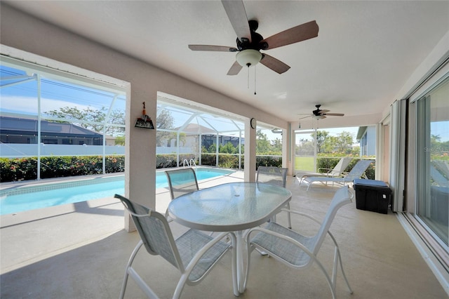 view of pool featuring a lanai, ceiling fan, and a patio area