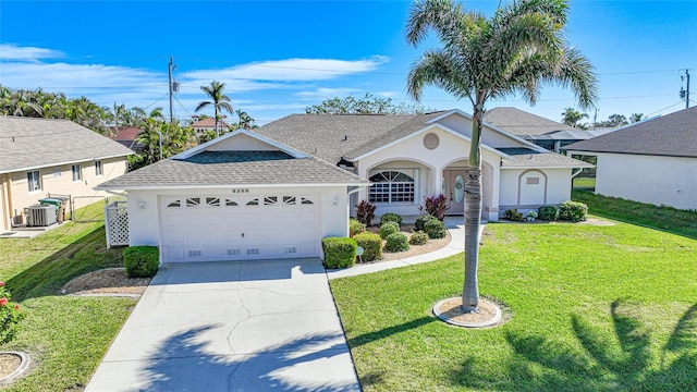 view of front of property with a garage, central AC, and a front yard