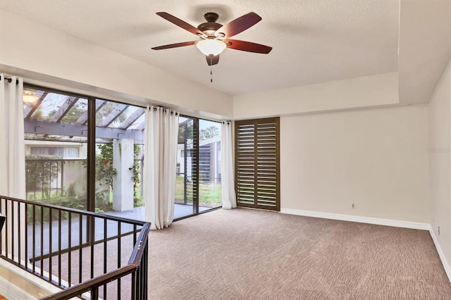 unfurnished bedroom with ceiling fan, carpet, and a textured ceiling