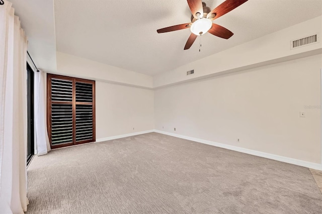 unfurnished bedroom featuring ceiling fan and light carpet