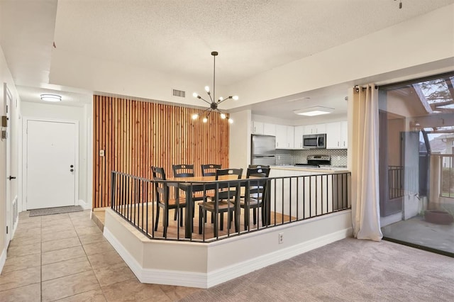 dining room featuring light tile patterned floors and a chandelier