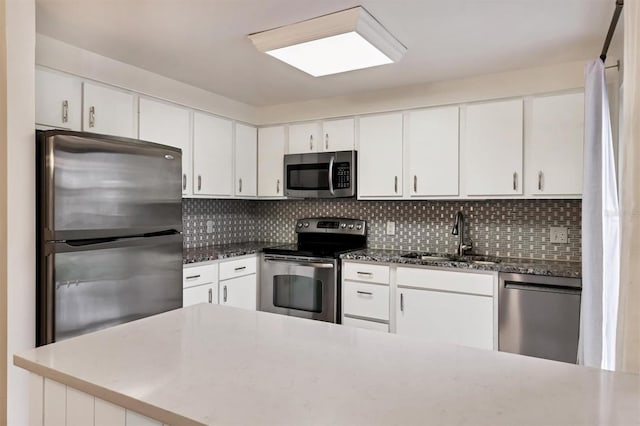 kitchen featuring white cabinetry, sink, tasteful backsplash, and stainless steel appliances