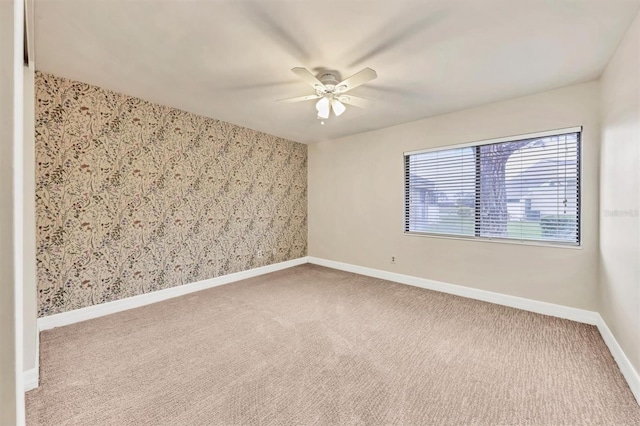 carpeted empty room with ceiling fan