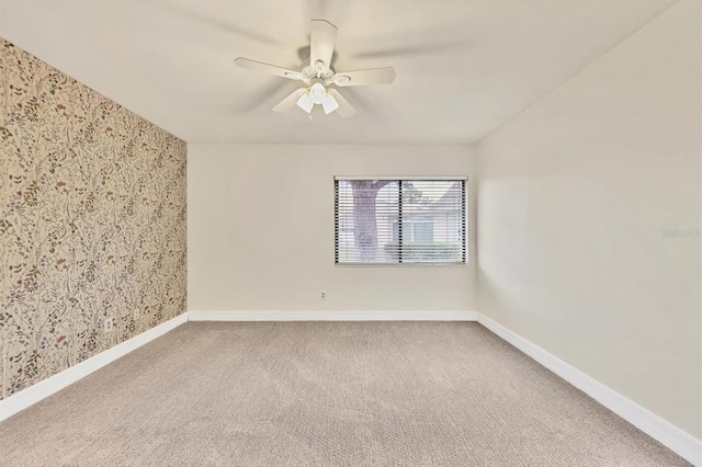 unfurnished room with ceiling fan and carpet flooring