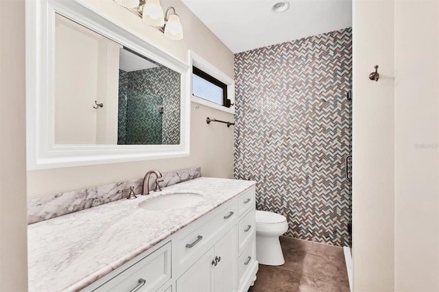 bathroom with vanity, a shower with shower door, tile patterned floors, and toilet