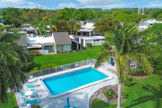 view of swimming pool with a patio and a lawn