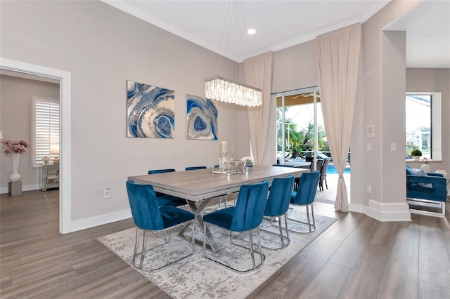 dining space featuring crown molding and dark hardwood / wood-style flooring