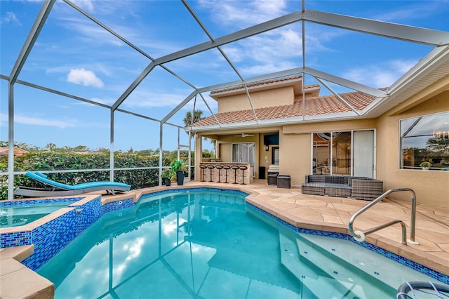 view of swimming pool with a patio, outdoor lounge area, an in ground hot tub, a lanai, and an outdoor bar