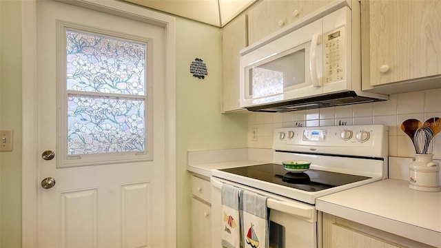 kitchen featuring tasteful backsplash, light brown cabinets, and white appliances