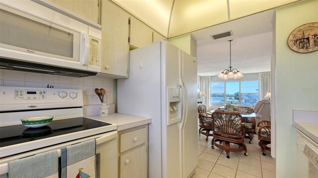 kitchen with light tile patterned flooring, decorative light fixtures, tasteful backsplash, a notable chandelier, and white appliances