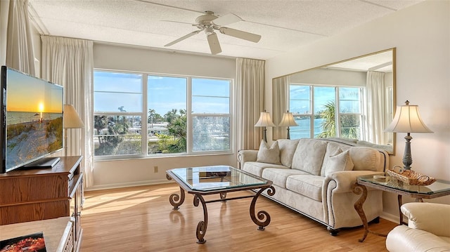 interior space with ceiling fan, light hardwood / wood-style floors, and a textured ceiling