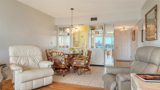 dining room featuring an inviting chandelier and light tile patterned floors