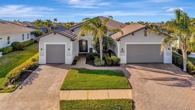 mediterranean / spanish-style house with a garage and a front yard